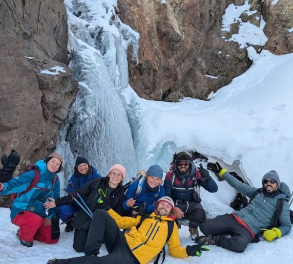 Trekkers navigating snowy conditions during a winter ascent of Mount Toubkal
